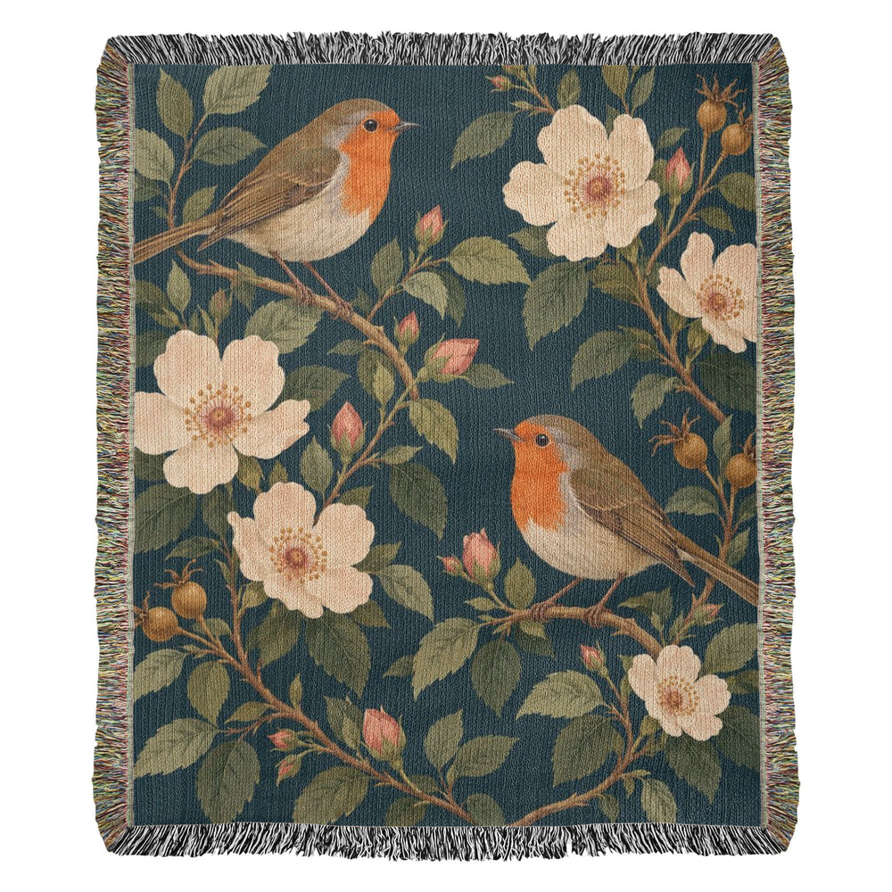 Bird Garden woven cotton blanket shown full front on a white background: robins perched on flowering branches with cream wild roses on deep teal, with fringed edges.