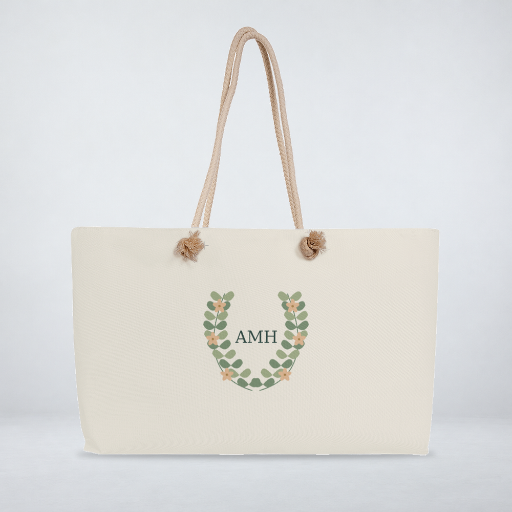 Botanical monogram weekender with cream rope handles and comfortably spaced AMH initials.