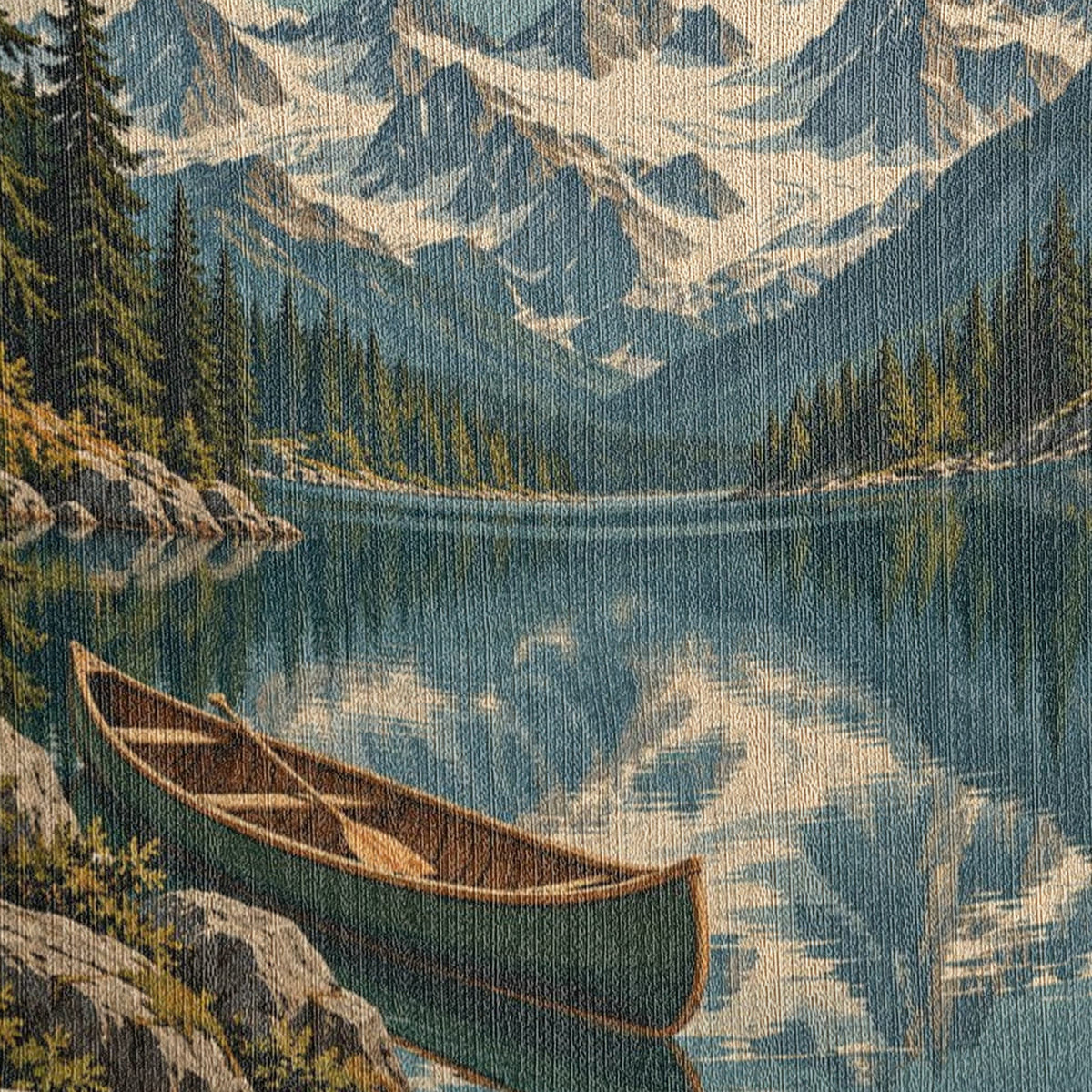 Close-up of the Mountain Lake woven cotton blanket: the tight cotton weave across the snowy peaks, pine forest, mirrored lake and the green wooden canoe.