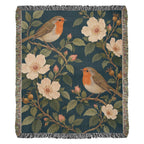 Bird Garden woven cotton blanket shown full front on a white background: robins perched on flowering branches with cream wild roses on deep teal, with fringed edges.