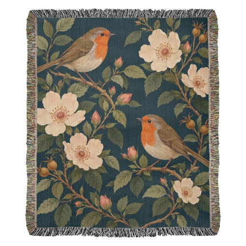 Bird Garden woven cotton blanket shown full front on a white background: robins perched on flowering branches with cream wild roses on deep teal, with fringed edges.