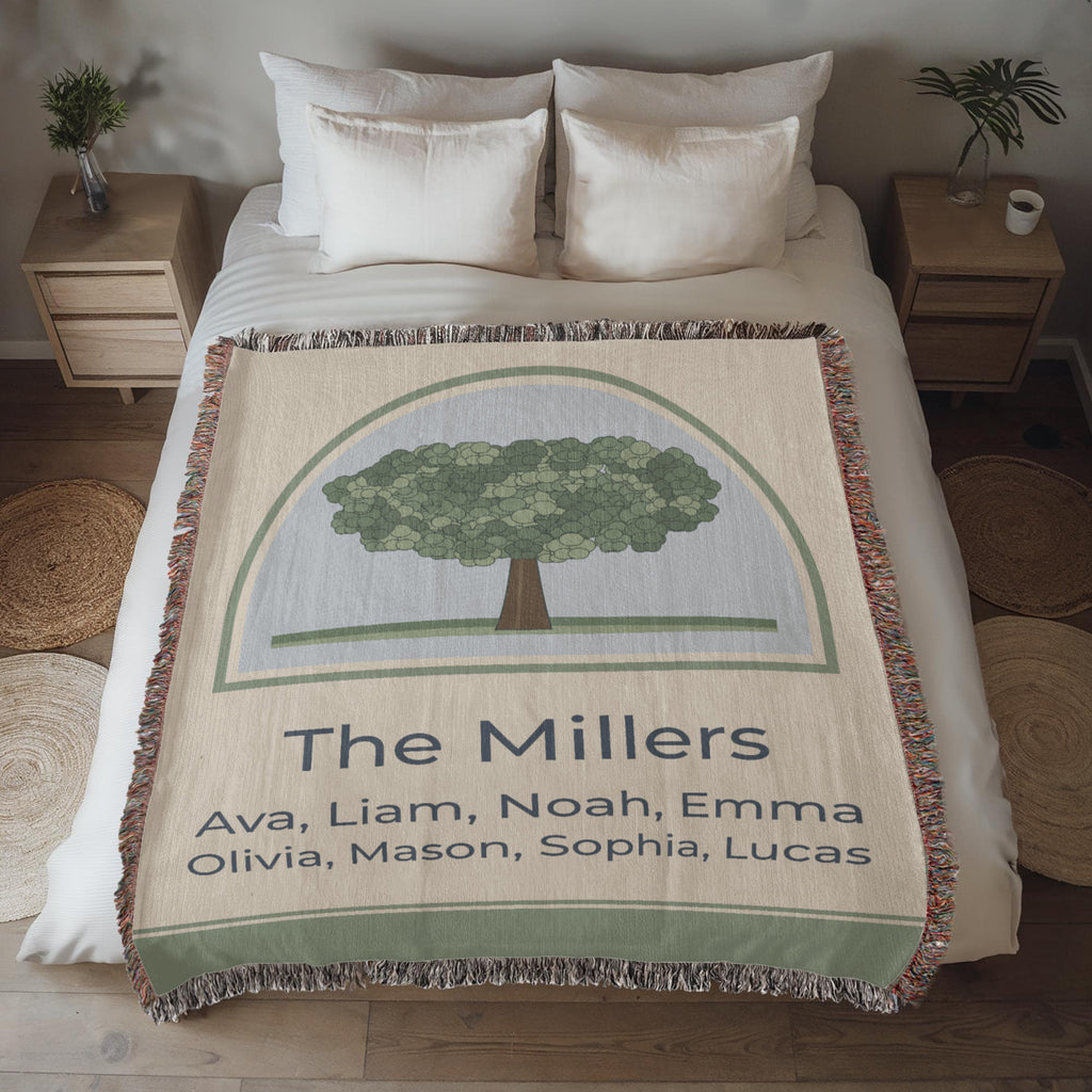 Family tree woven blanket spread across a made bed, oak canopy with The Millers and family names in the cream band
