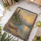 Be Still lake woven throw spread on a white porch floor beside potted plants