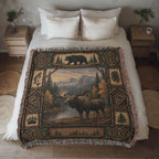 Lodge woven throw spread across a made bed, moose by the lake framed by pine panels, diamond medallions and a walking black bear
