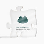 Clear acrylic puzzle-piece caregiver plaque on a white background, printed with a green design and the text "For Maria Alvarez" and "With gratitude for all you do"