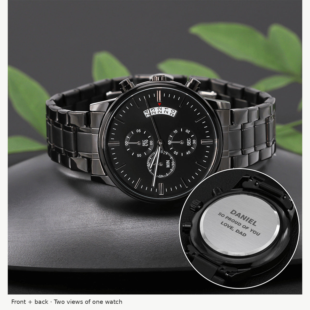 Black stainless steel chronograph front and engraved back on gray surface