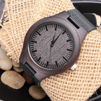 Wooden watch front on burlap with stones