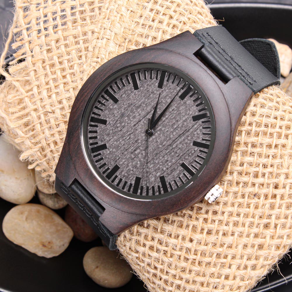 Wooden watch front on burlap with stones