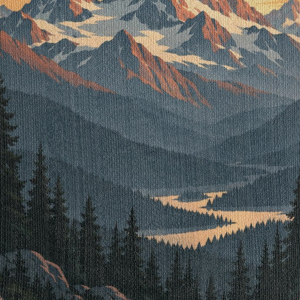 Macro close-up of the Mountain Sunrise woven cotton blanket showing the tight cotton weave across the misty blue mountain ridges, the winding golden river and the dark pine forest.