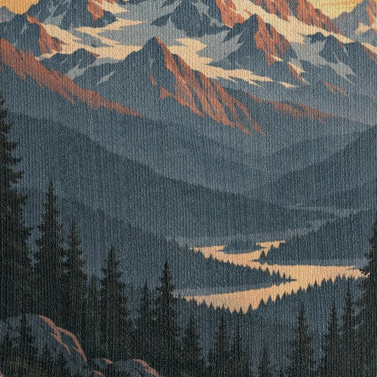 Macro close-up of the Mountain Sunrise woven cotton blanket showing the tight cotton weave across the misty blue mountain ridges, the winding golden river and the dark pine forest.