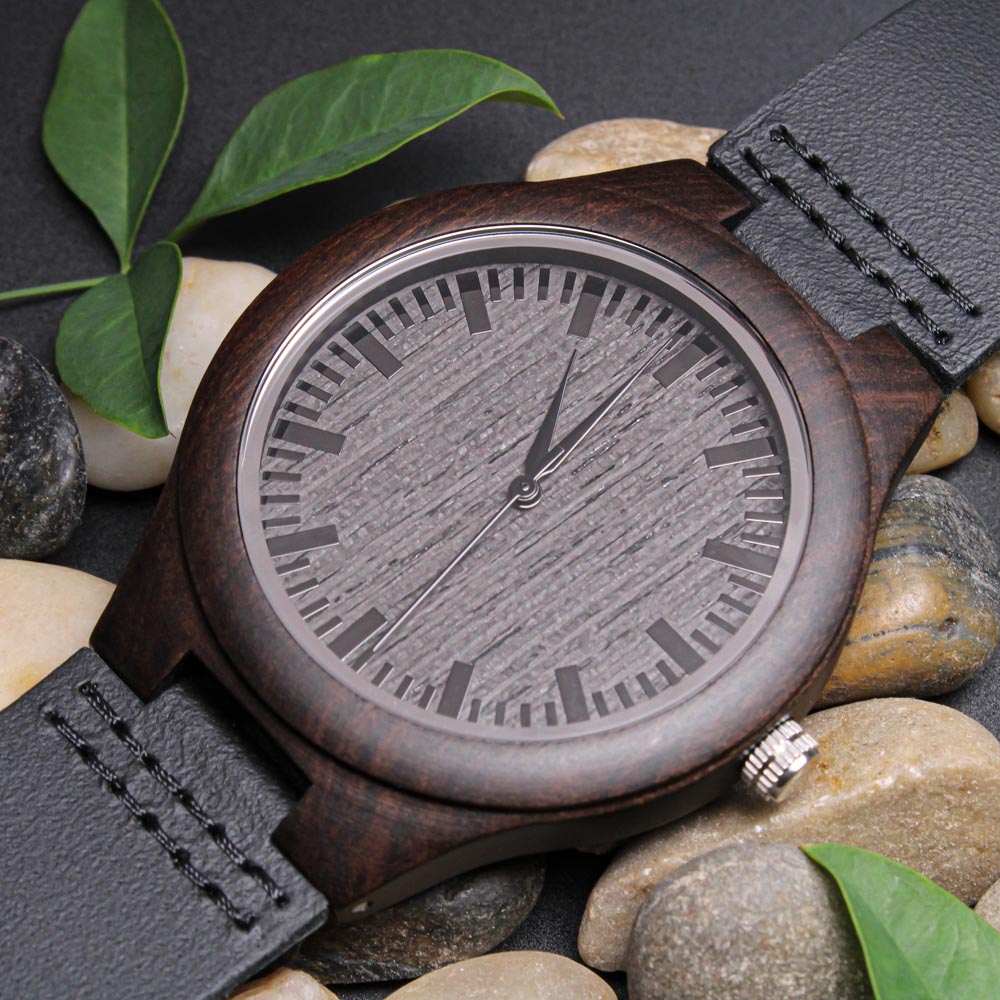 Wooden watch front with leaves and stones
