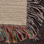 Corner close-up of the Family Caravan woven cotton blanket showing the cream cotton weave, the multicolour bottom fringe and the black-and-white side fringe.