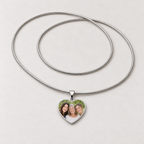 Steel heart photo necklace with a family photo of three smiling women on the pendant and a full snake chain