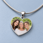 Close view of the family photo, polished silver-tone heart rim, tapered bail and snake chain