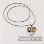 Photo heart pendant measuring 24 mm wide, shown above a metric ruler