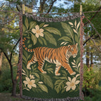 Tiger Botanical woven cotton blanket hanging from a clothesline among trees, showing the whole tiger, botanical leaves and fringed edges.