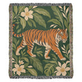 Tiger Botanical woven cotton blanket shown full front on a white background: a striding orange tiger among cream blossoms and green leaves on deep green, with fringed edges.