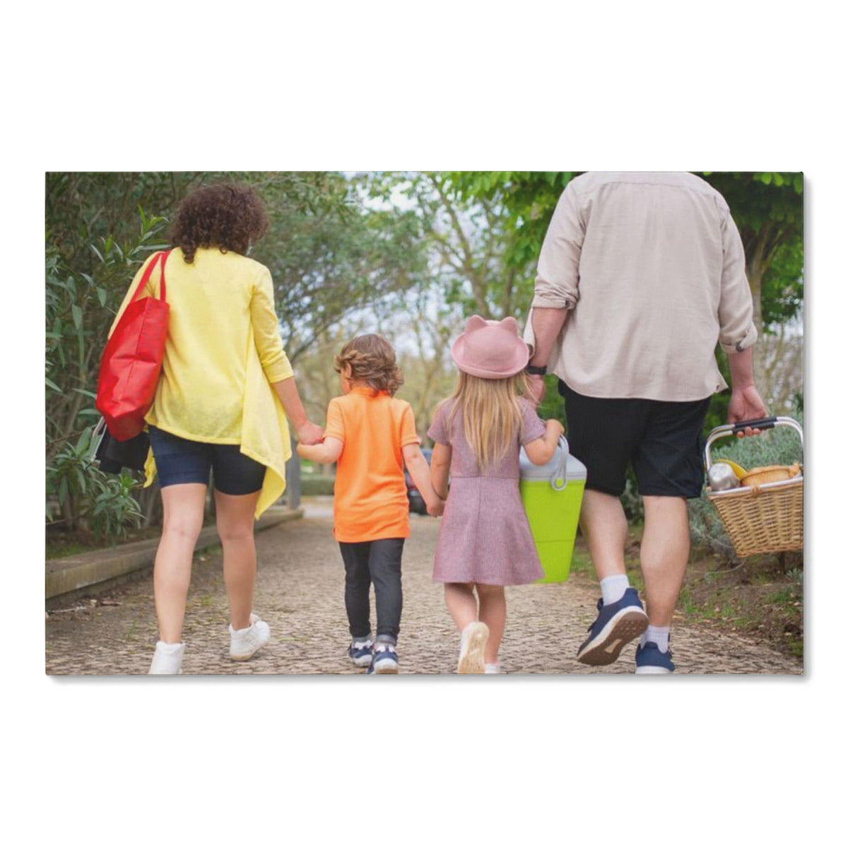 Custom family portrait canvas from one photo, front view of a gallery-wrapped canvas printed edge to edge with a family walking hand in hand along a park path.