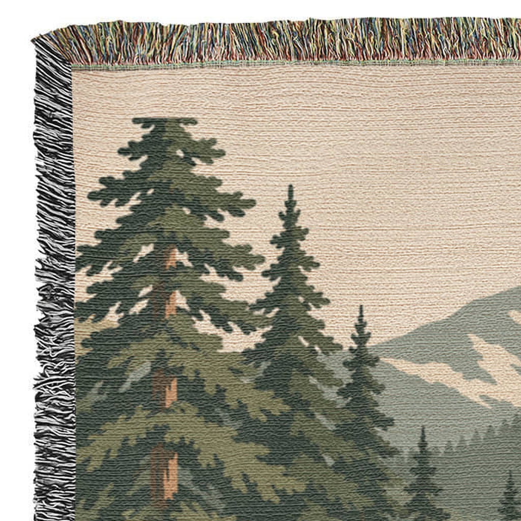 Corner of the cabin woven blanket showing the multicolor fringe along the edge
