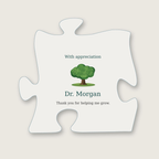 Clear acrylic puzzle-piece plaque with the heading "With appreciation", a small green oak tree illustration, the name "Dr. Morgan" and the message "Thank you for helping me grow."