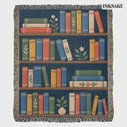 Book Garden woven cotton blanket with colorful bookshelves, trailing plants and fringed edges