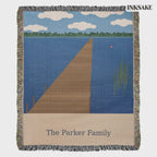 Personalized lake dock woven blanket with The Parker Family lettering, shown full length and laid on the floor