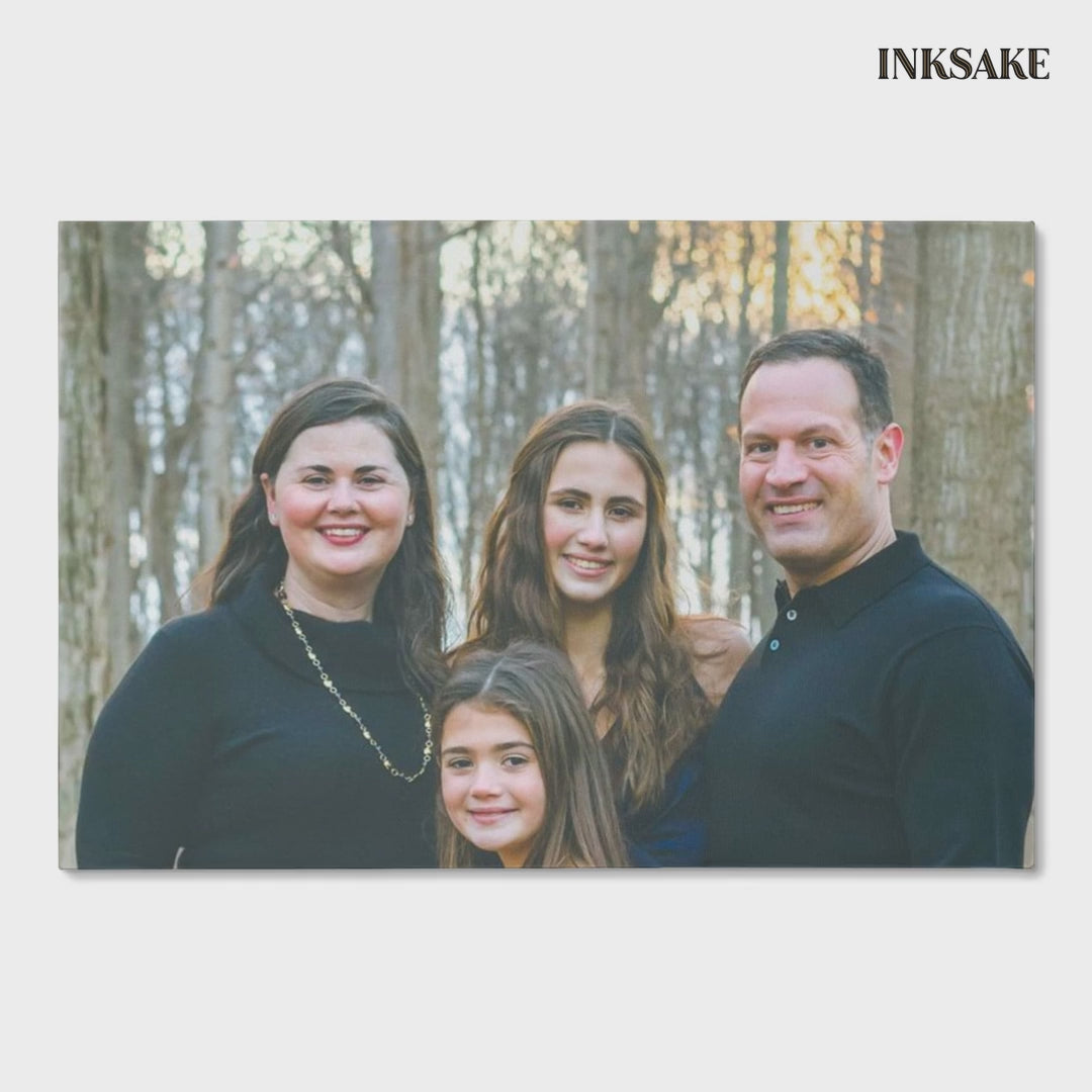Custom family portrait canvas of a family of four, printed edge to edge and gallery-wrapped, shown from the front and leaning on a wood floor.